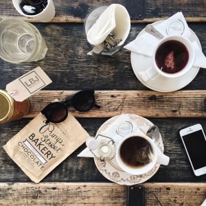 work station table with tea sunglasses cell phone